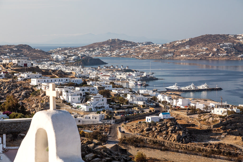 Greek island town with white buildings and a blue sea