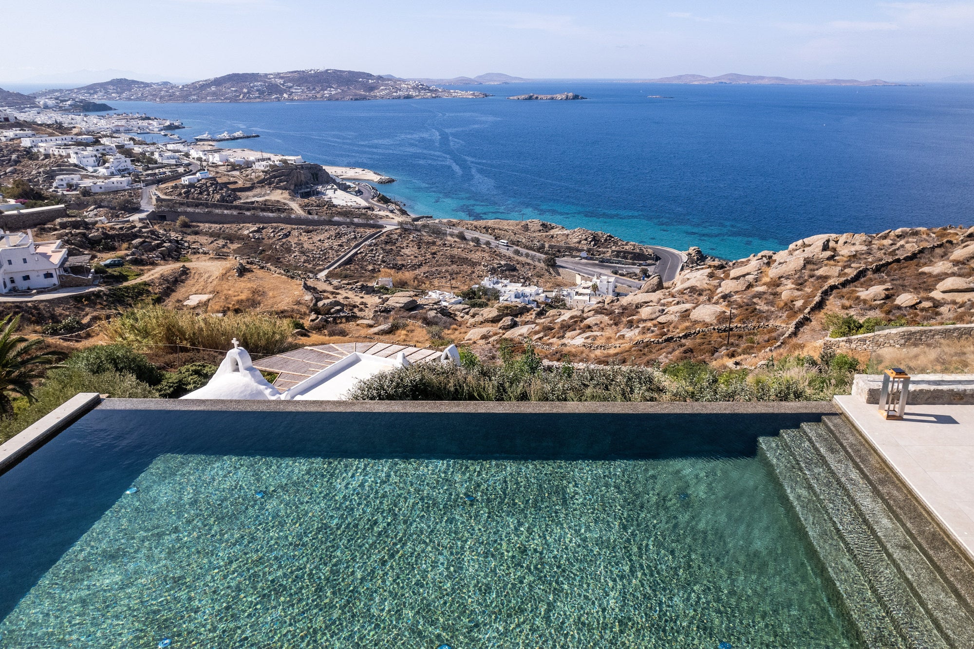 Pool with scenic view of coastal landscape and blue sea