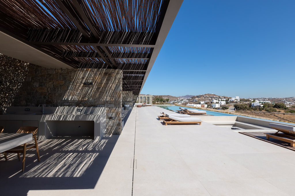 Modern outdoor patio with pool and clear blue sky