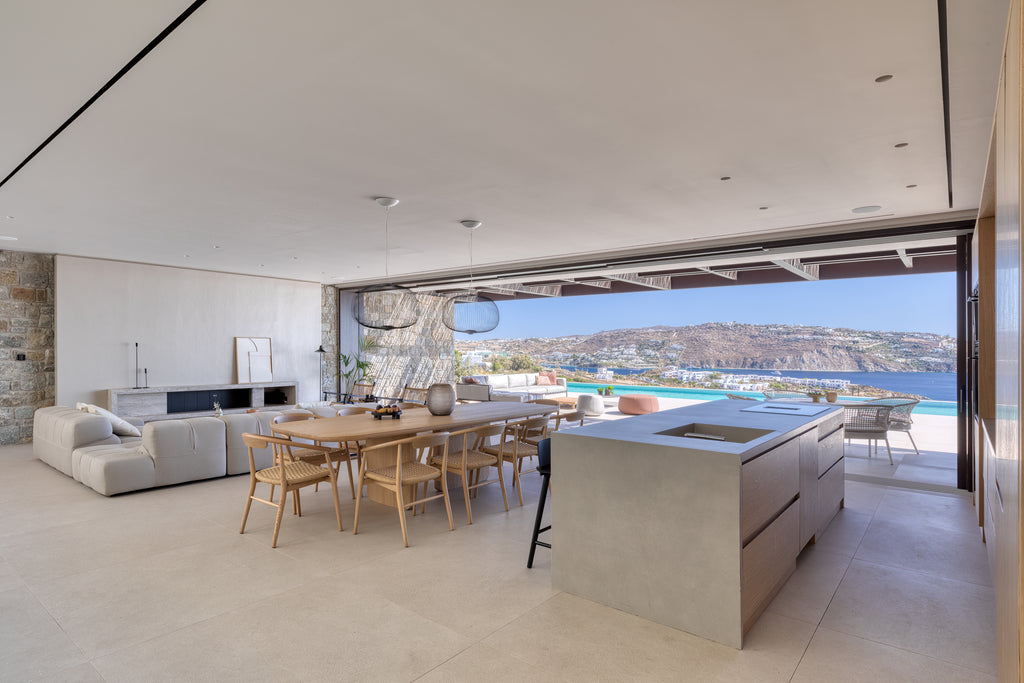 Modern kitchen and dining area with a view of a scenic landscape.
