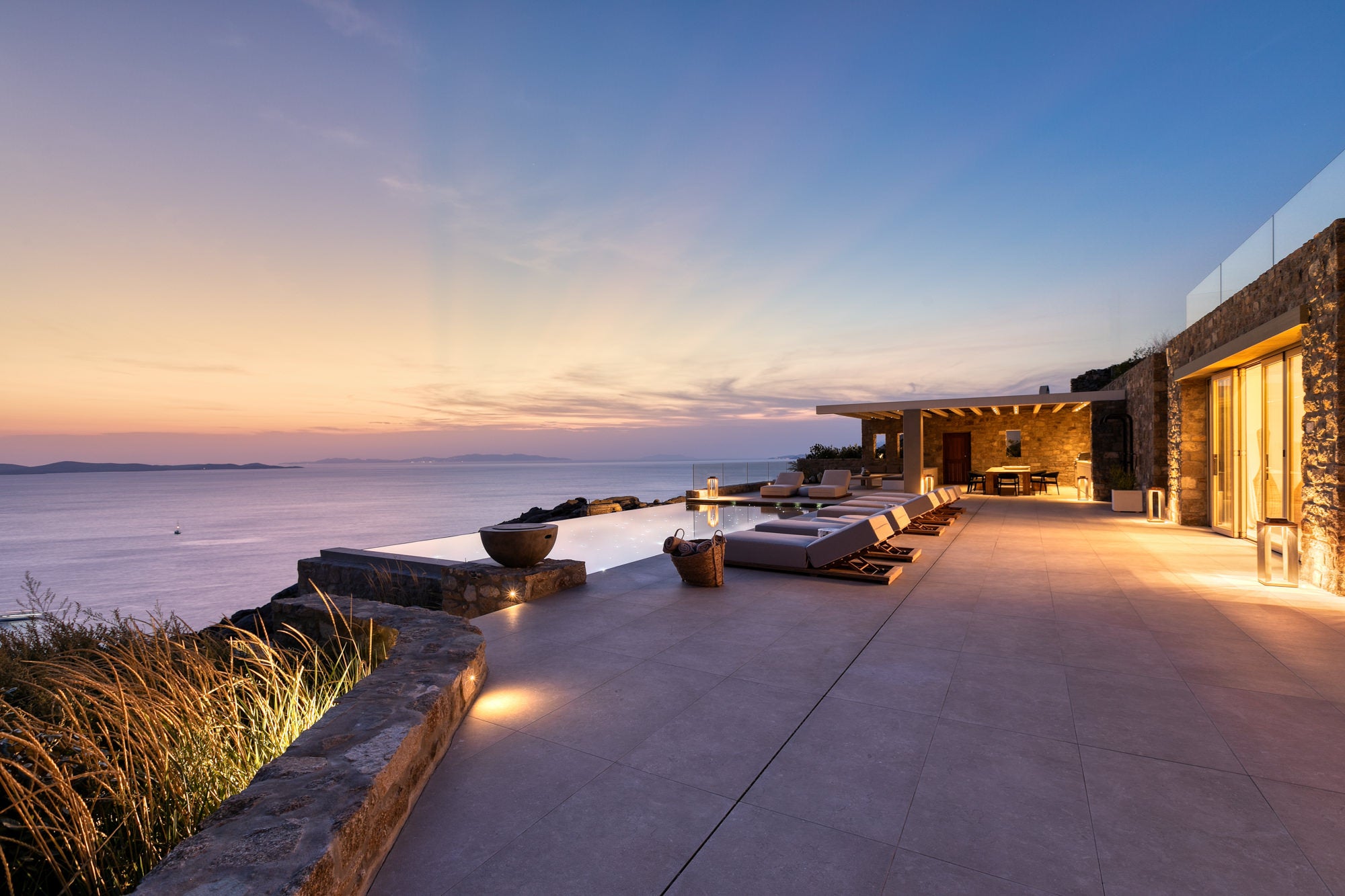 Outdoor patio area with ocean view during sunset