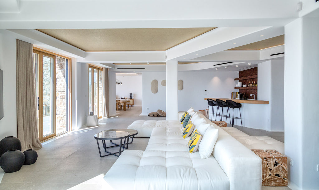 Modern living room with white furniture and large windows