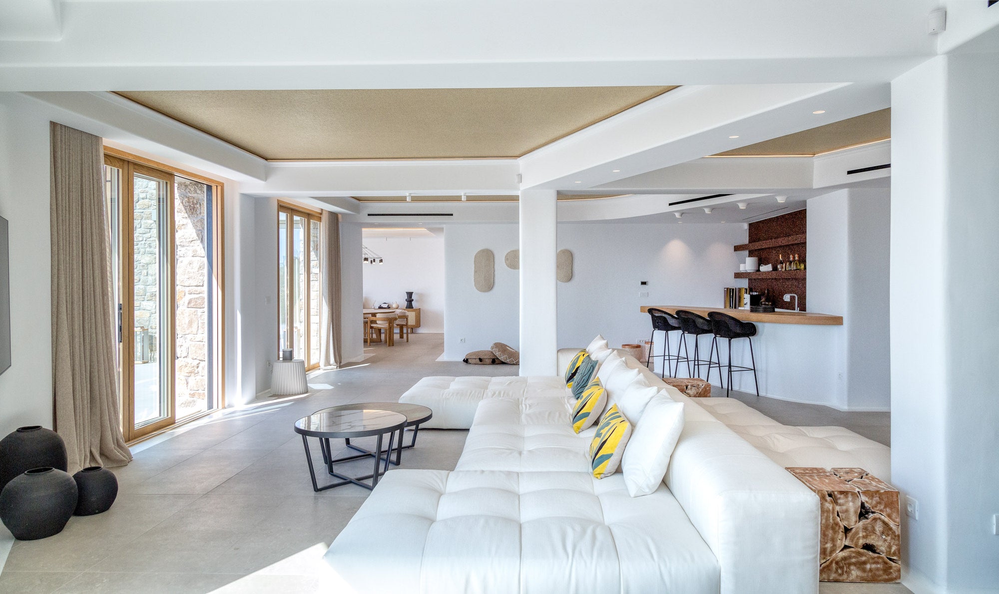 Modern living room with white furniture and large windows