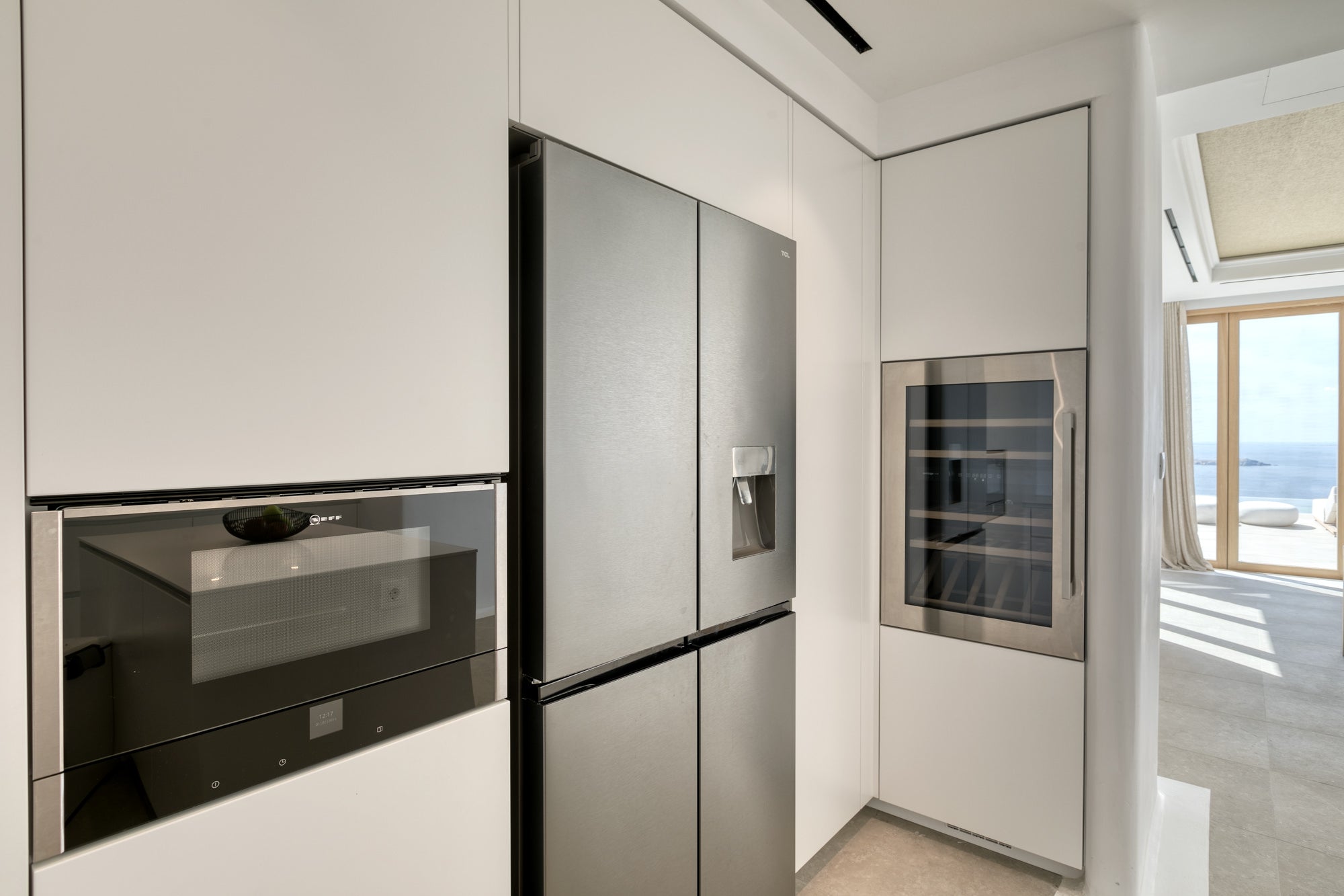 Modern kitchen with stainless steel appliances including a refrigerator and oven.