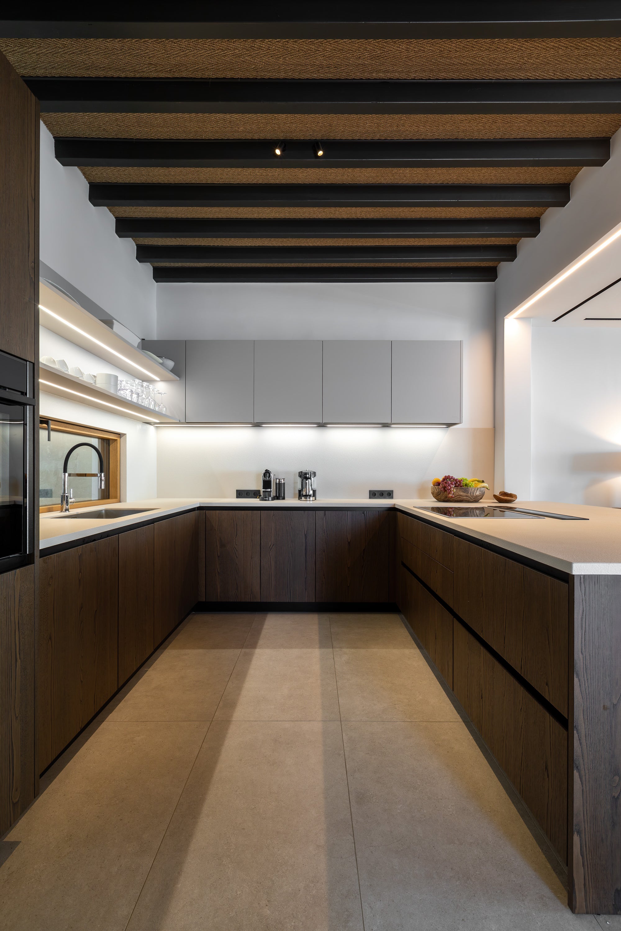 Modern kitchen with wooden ceiling beams and white walls