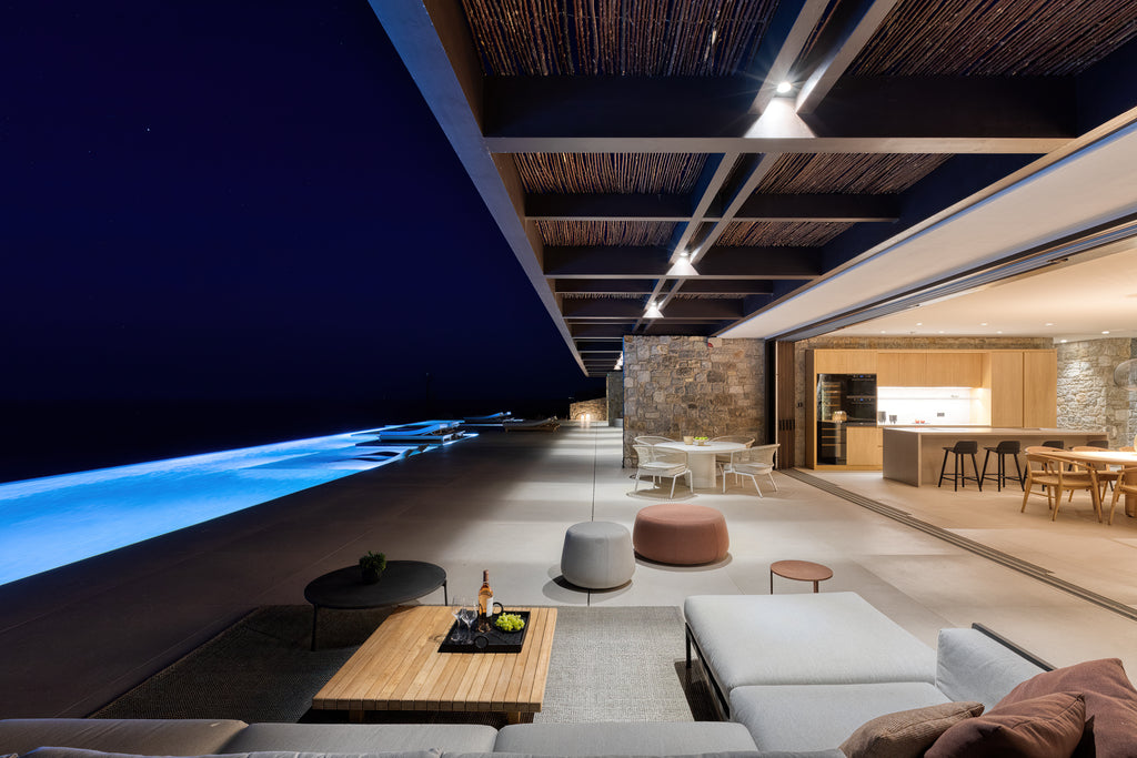 Modern outdoor living area with pool at night