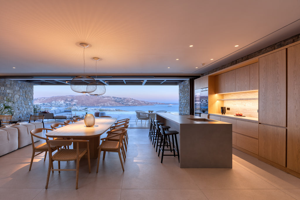 Modern kitchen and dining area with a view of the ocean.