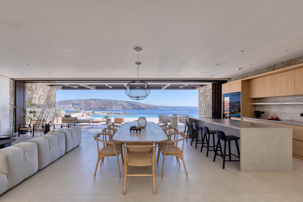 Modern kitchen and dining area with a view of the ocean.