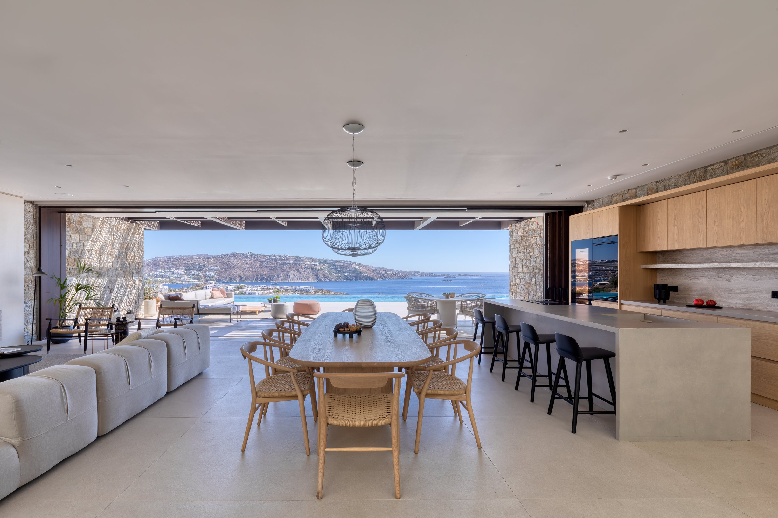 Modern kitchen and dining area with a view of the ocean.