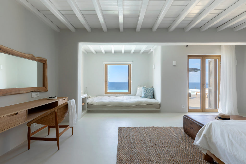 Modern bedroom with desk, bed, and ocean view