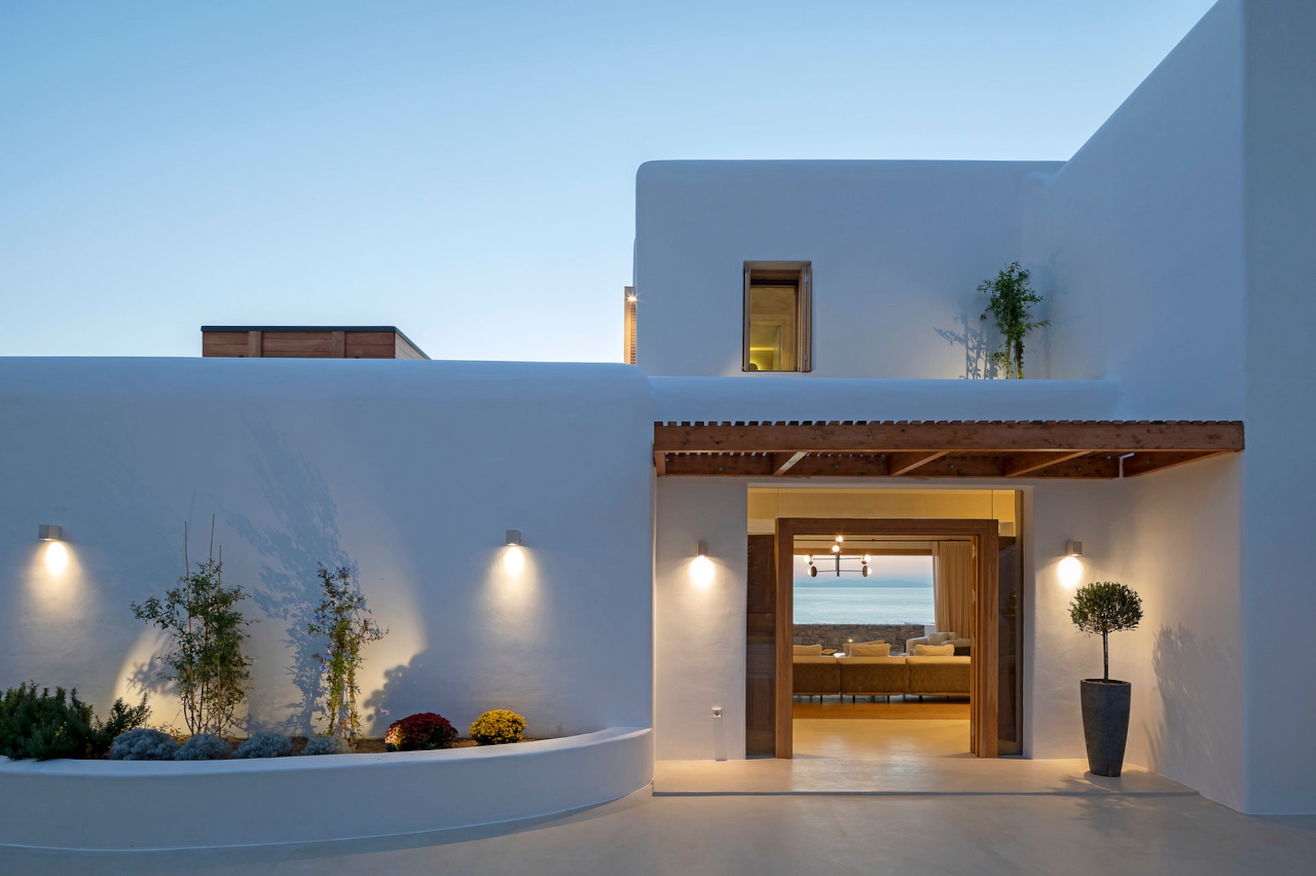 Modern white house exterior with a welcoming entrance at dusk.