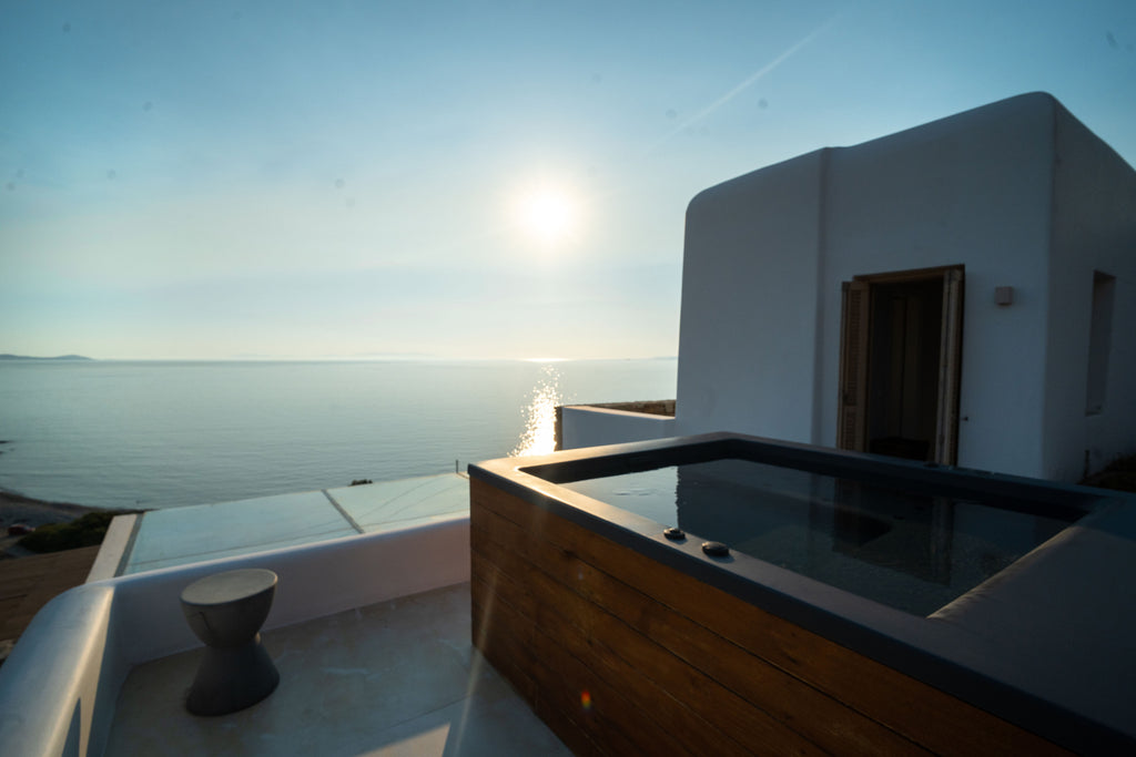 Outdoor hot tub with ocean view during sunset