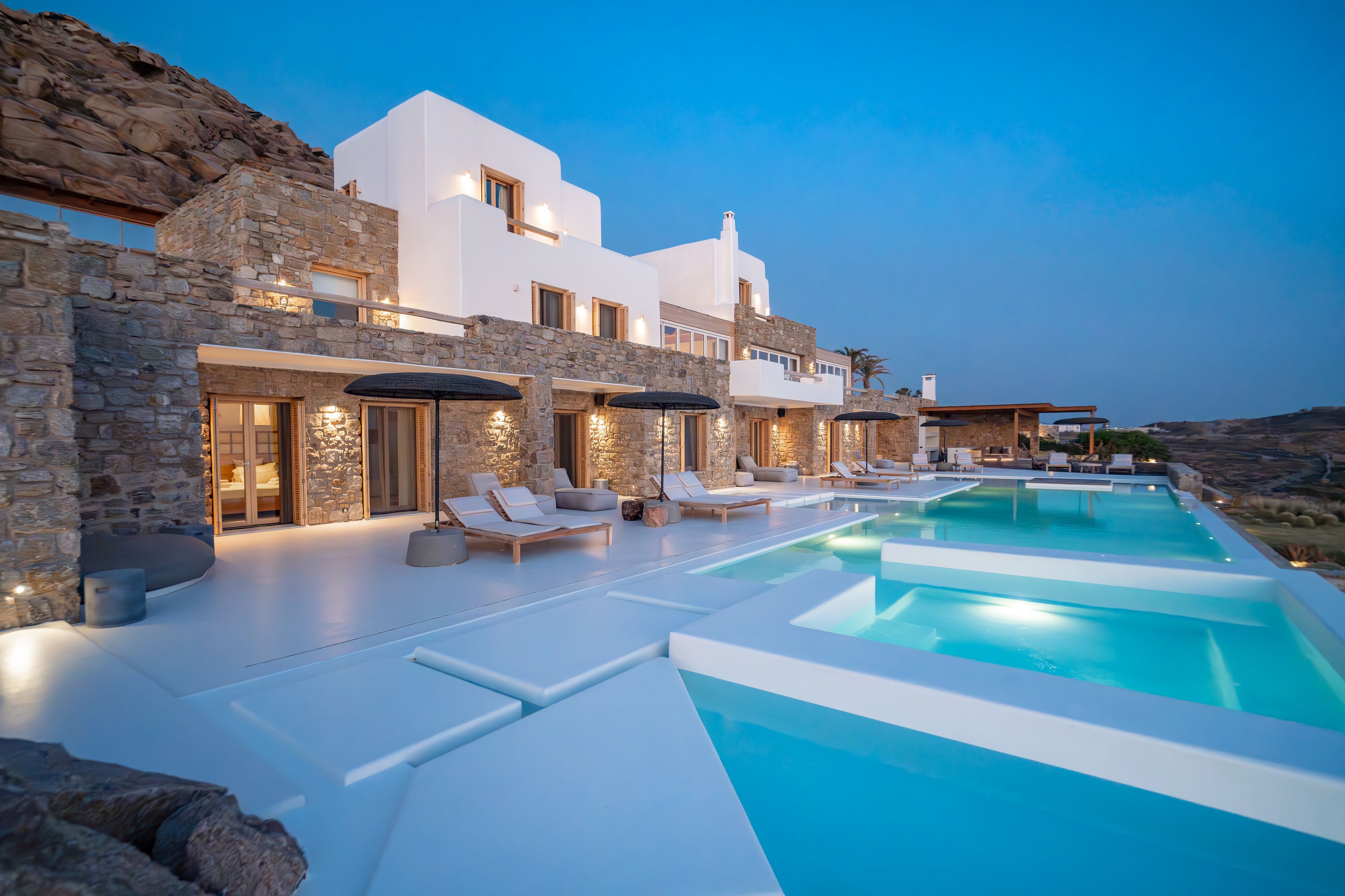 Modern architectural house with a pool at dusk