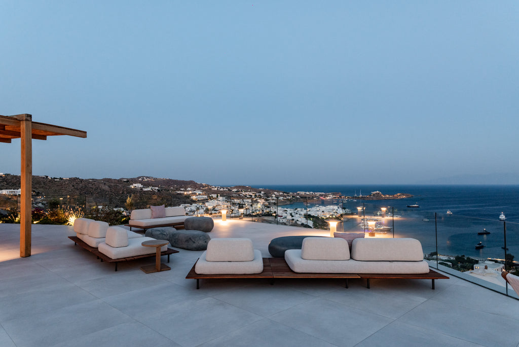 Outdoor seating area with ocean view at dusk