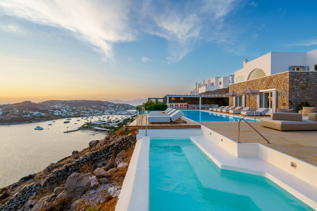Luxury pool area with ocean view and white buildings