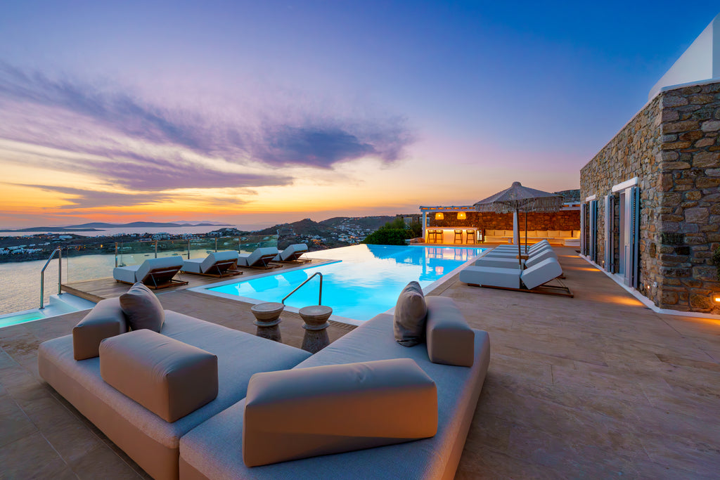 Luxury outdoor pool area with sunset view and modern furniture