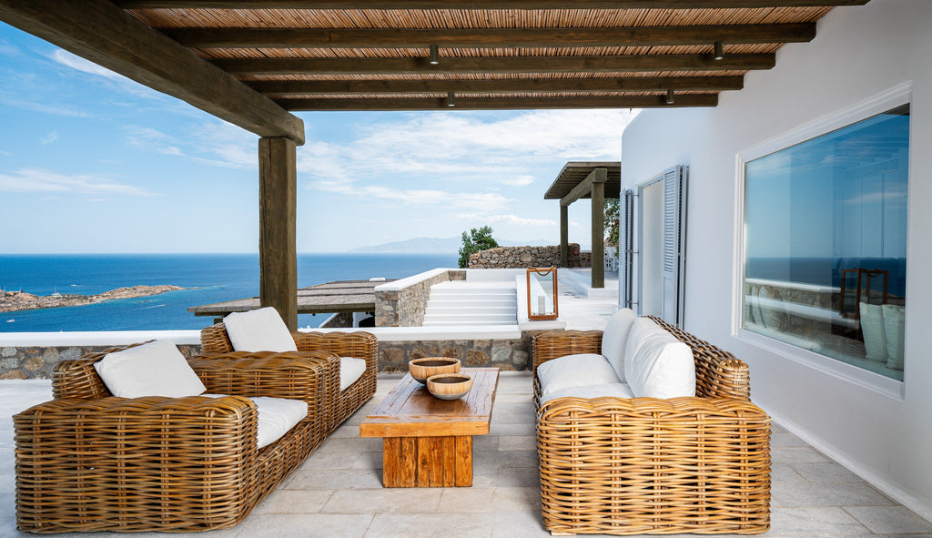 Outdoor patio with wicker furniture and ocean view