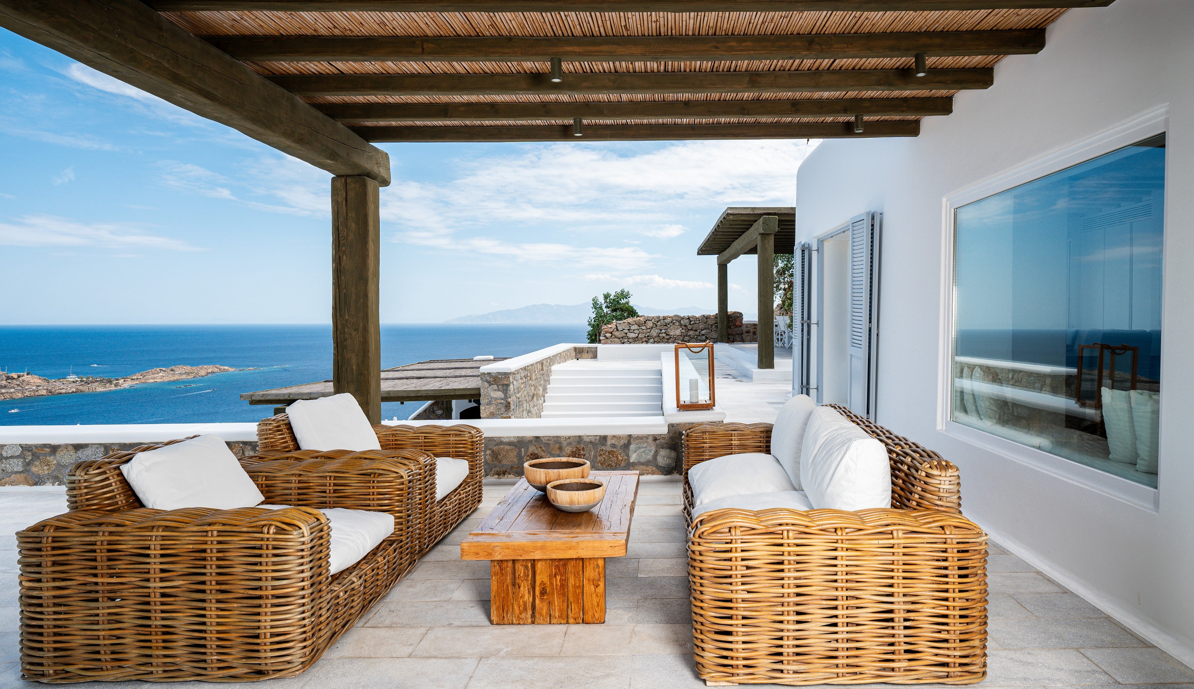 Outdoor patio with wicker furniture and ocean view