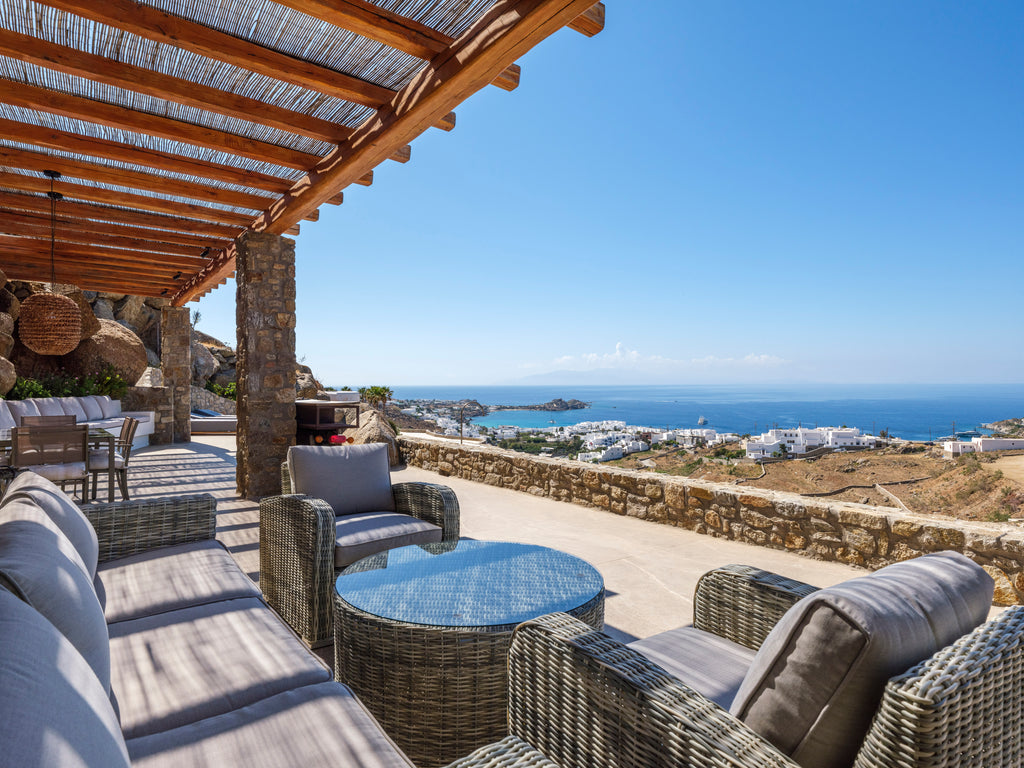 Outdoor patio with wicker furniture and ocean view