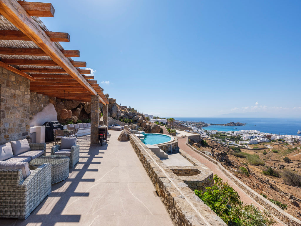 Outdoor patio area with pool and ocean view