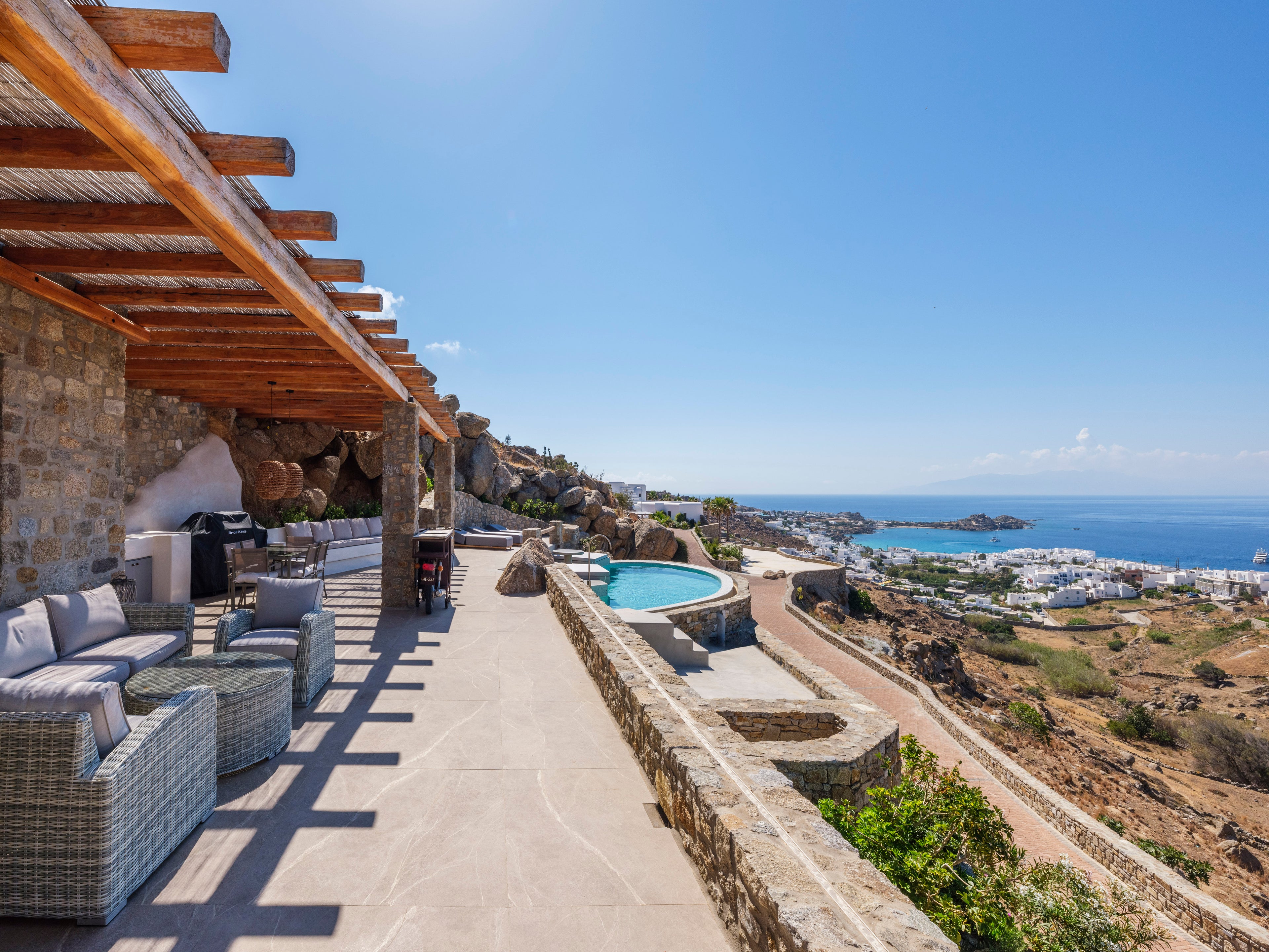 Outdoor patio area with pool and ocean view