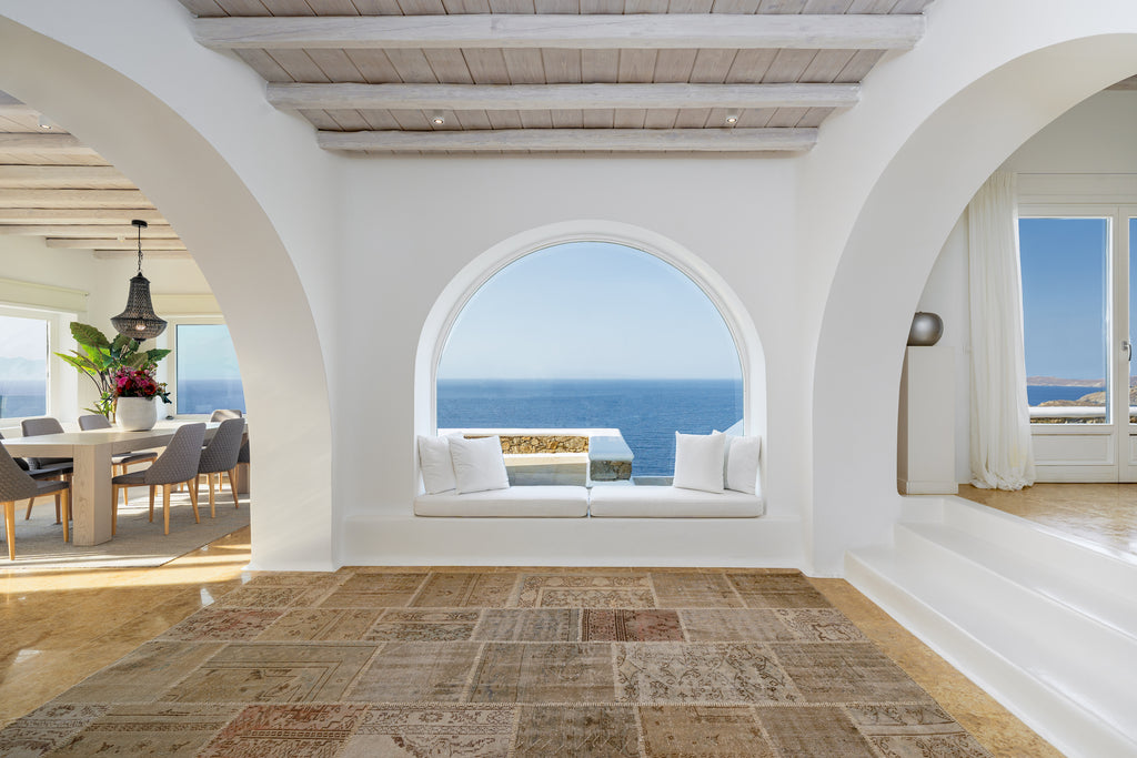 Modern interior with white walls, wooden floor, and ocean view