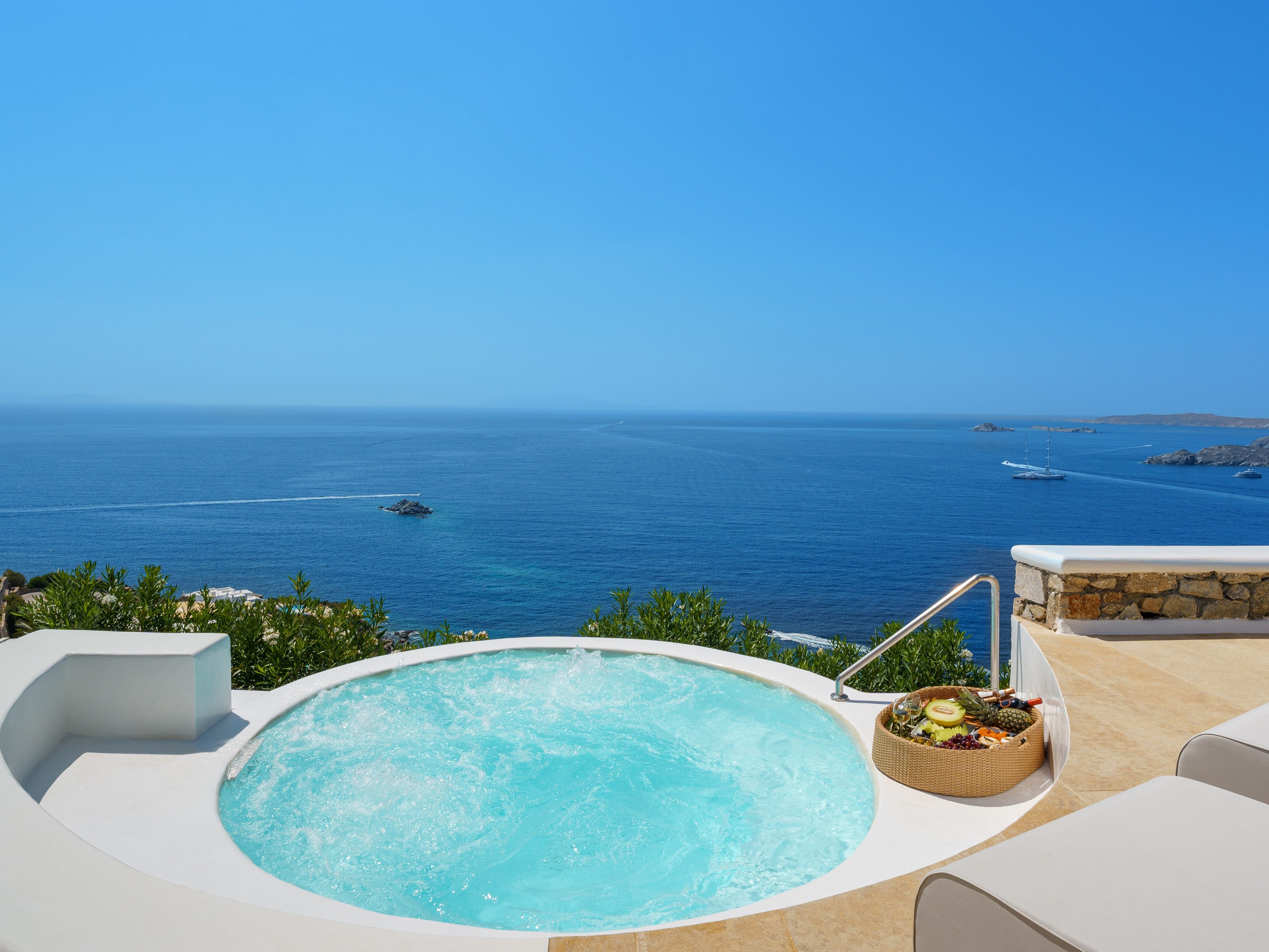 Hot tub with ocean view and clear blue sky