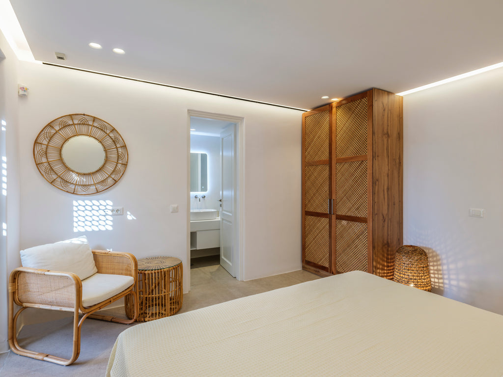 Modern bedroom with wooden wardrobe, bed, and chair.