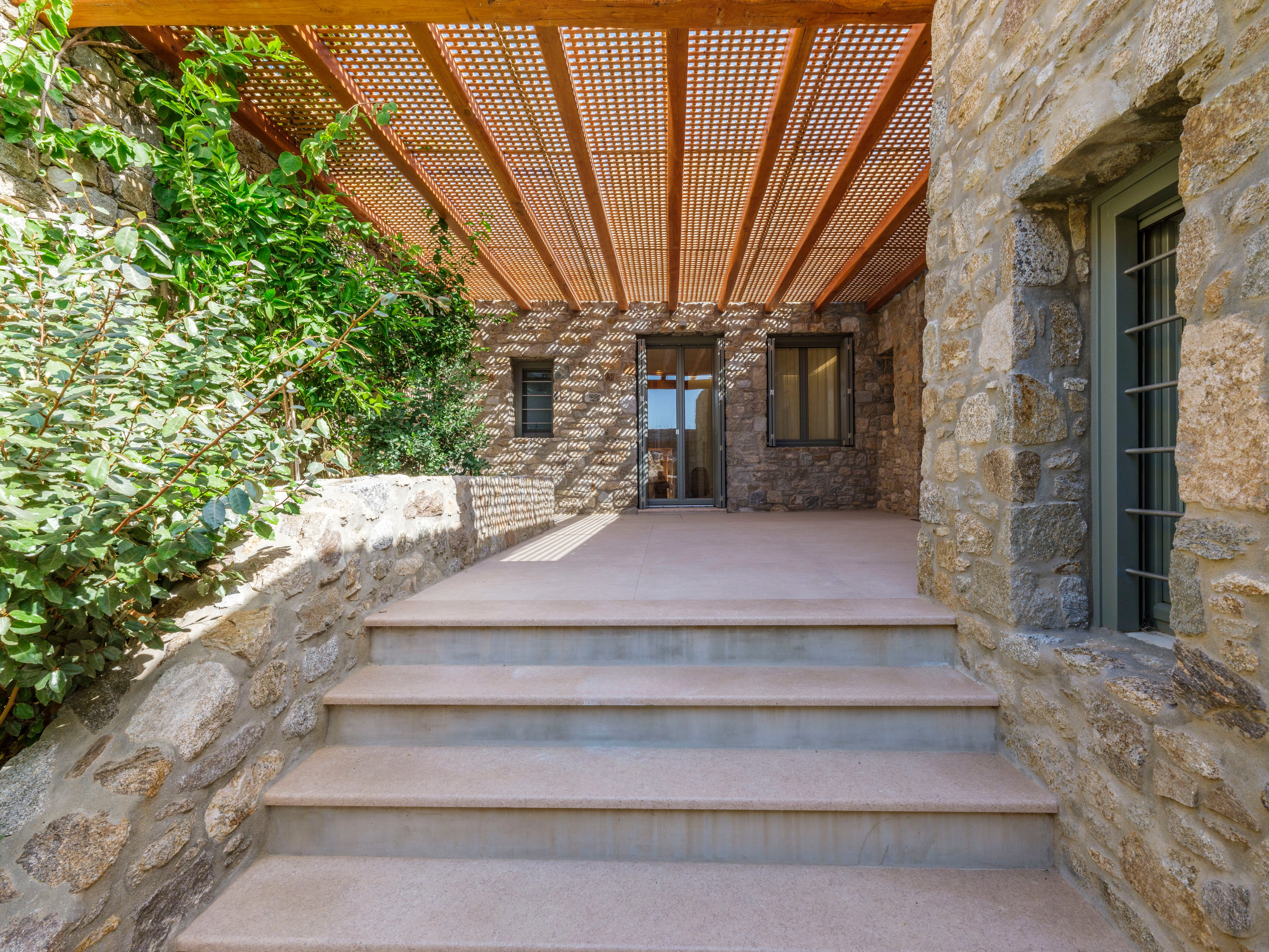 Stairway leading to a stone building with a modern design