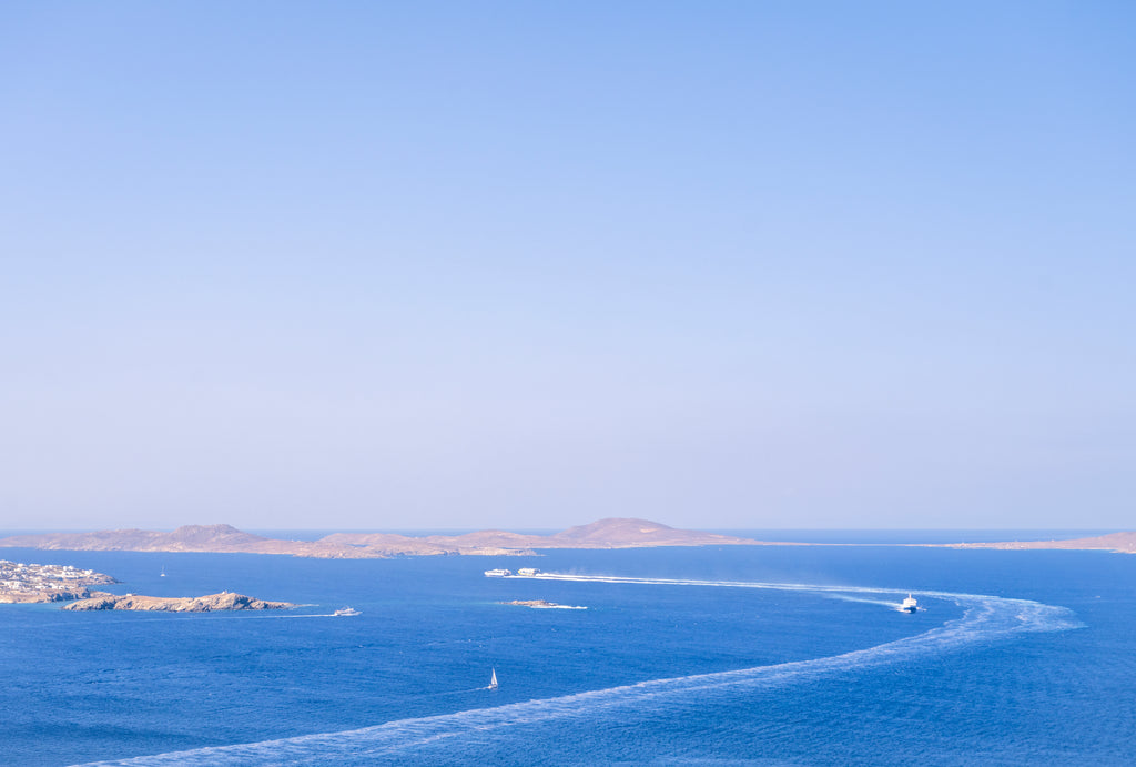 Blue ocean with a small island and clear sky