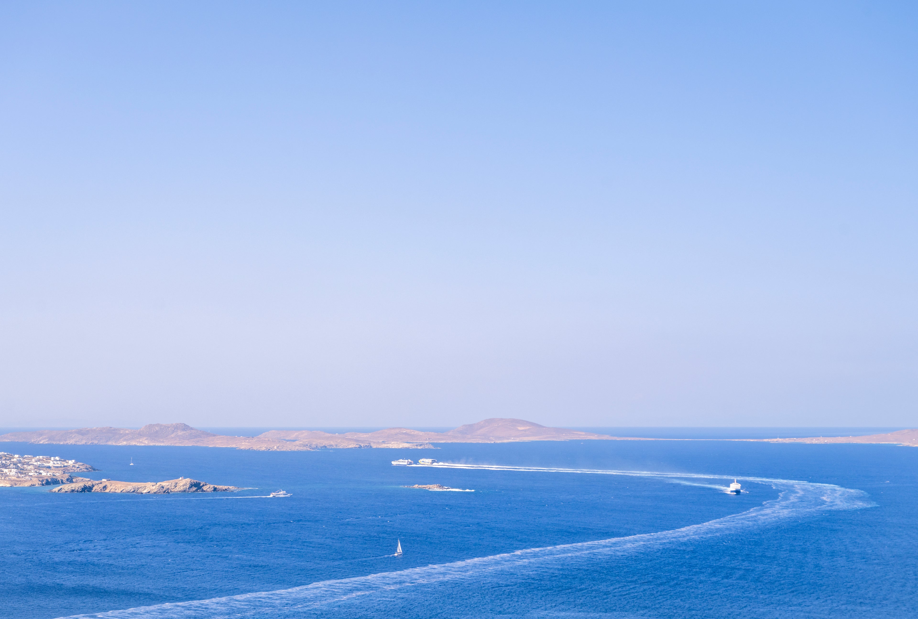 Blue ocean with a small island and clear sky