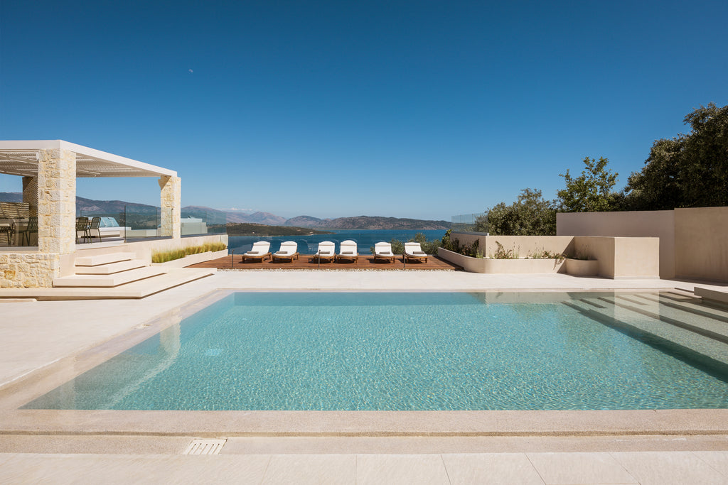 Modern pool area with lounge chairs and scenic view