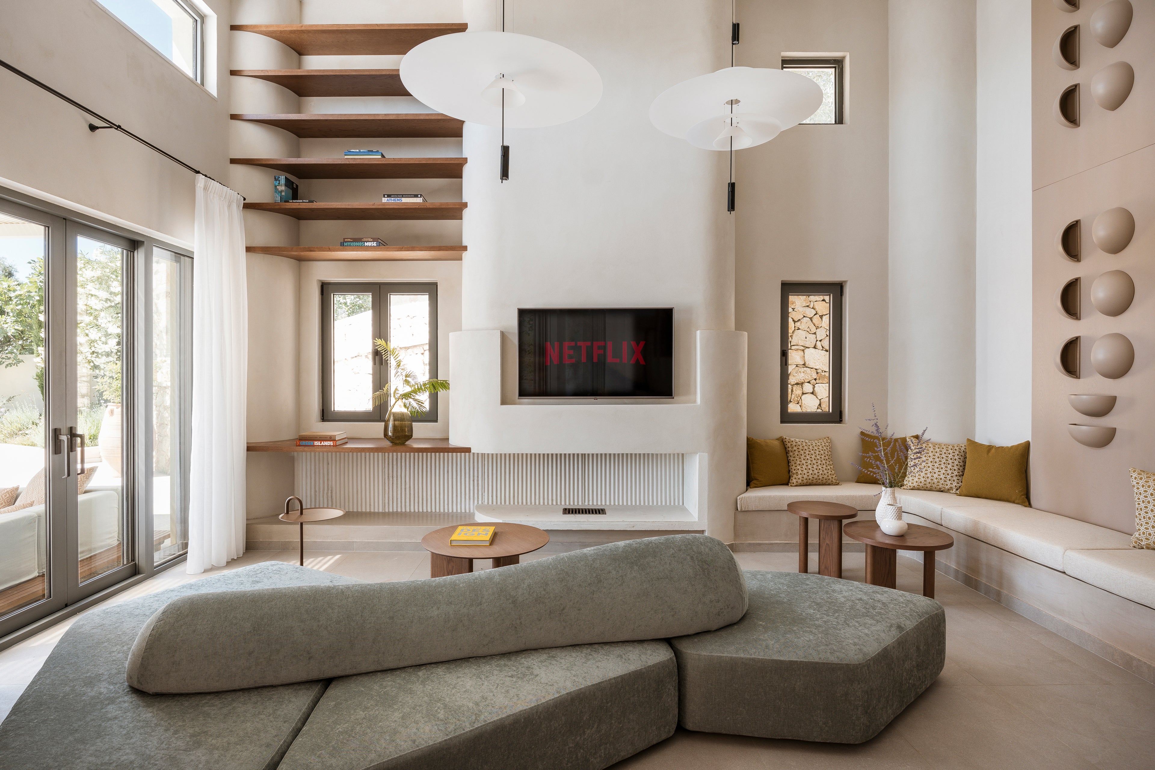 Modern living room with a large sectional sofa, coffee table, and decorative elements.