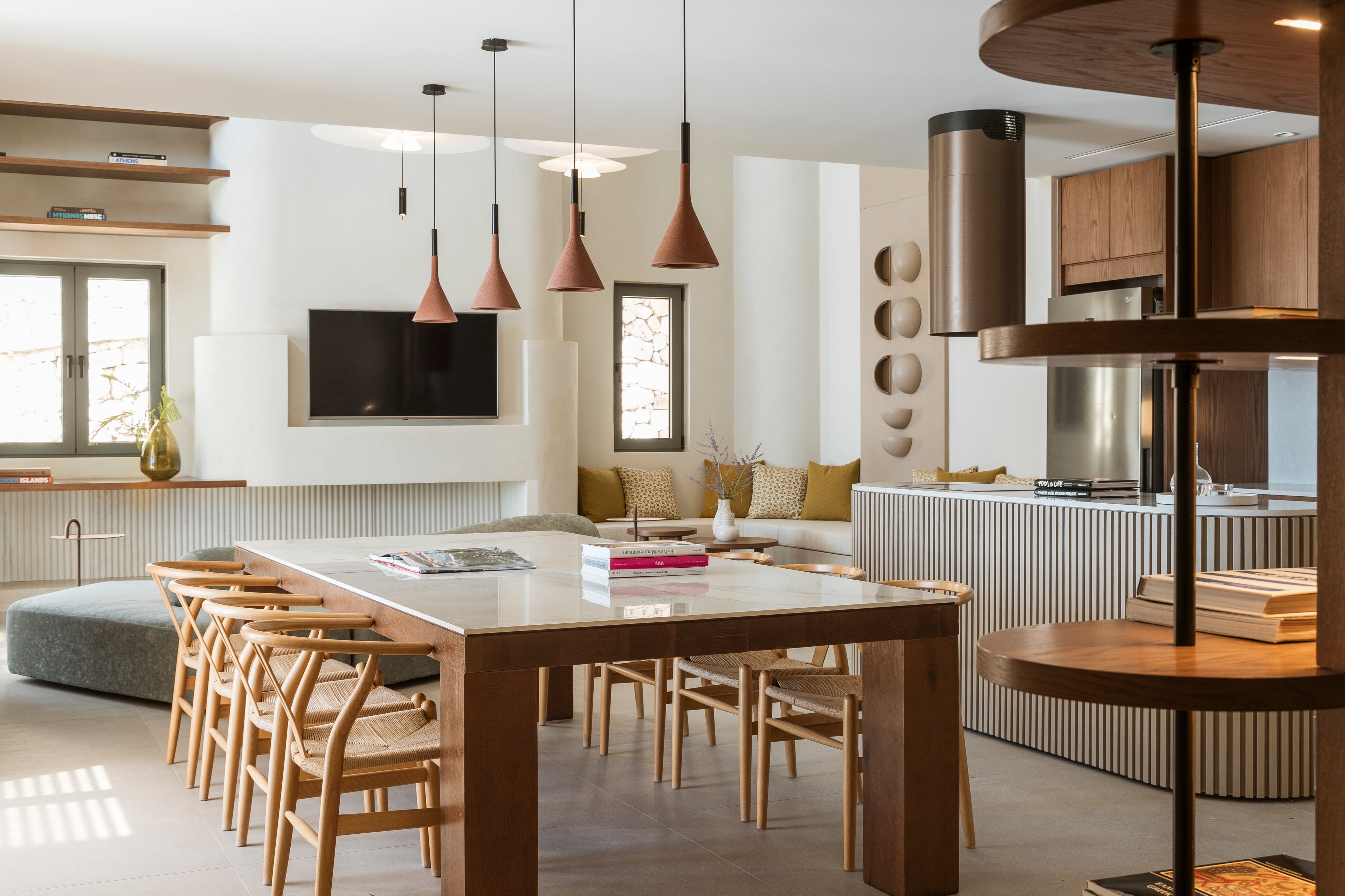 Modern kitchen and dining area with a large table and chairs.