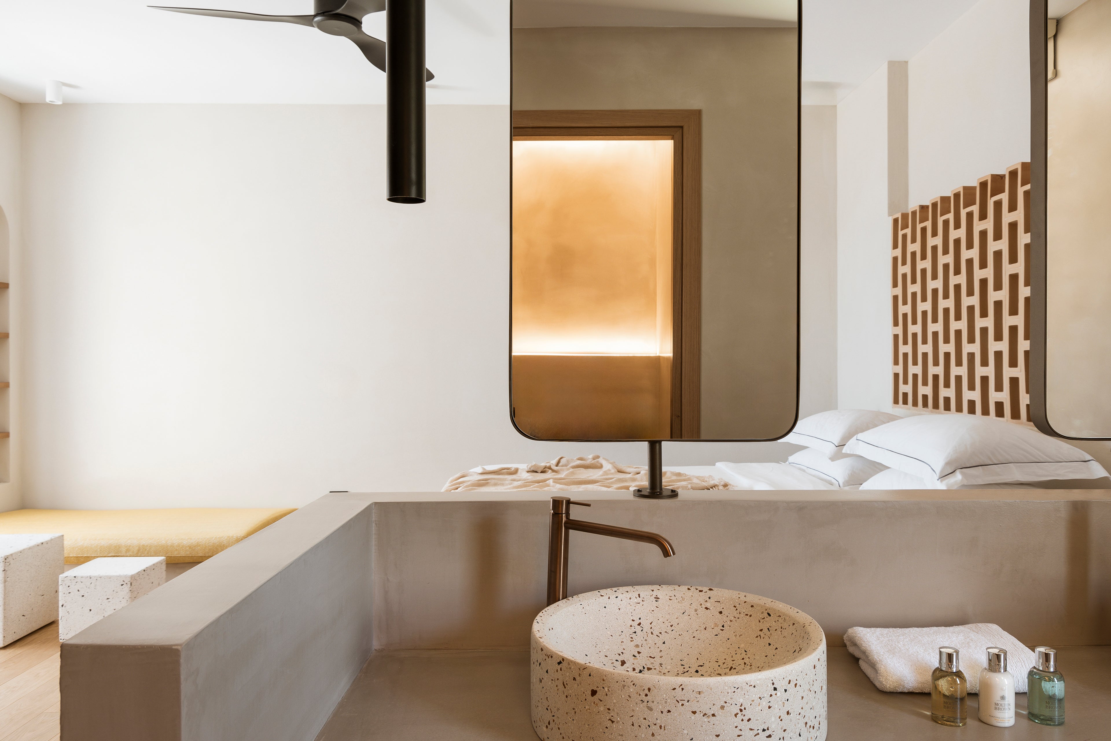 Modern bathroom with a sink, mirror, and decorative elements.
