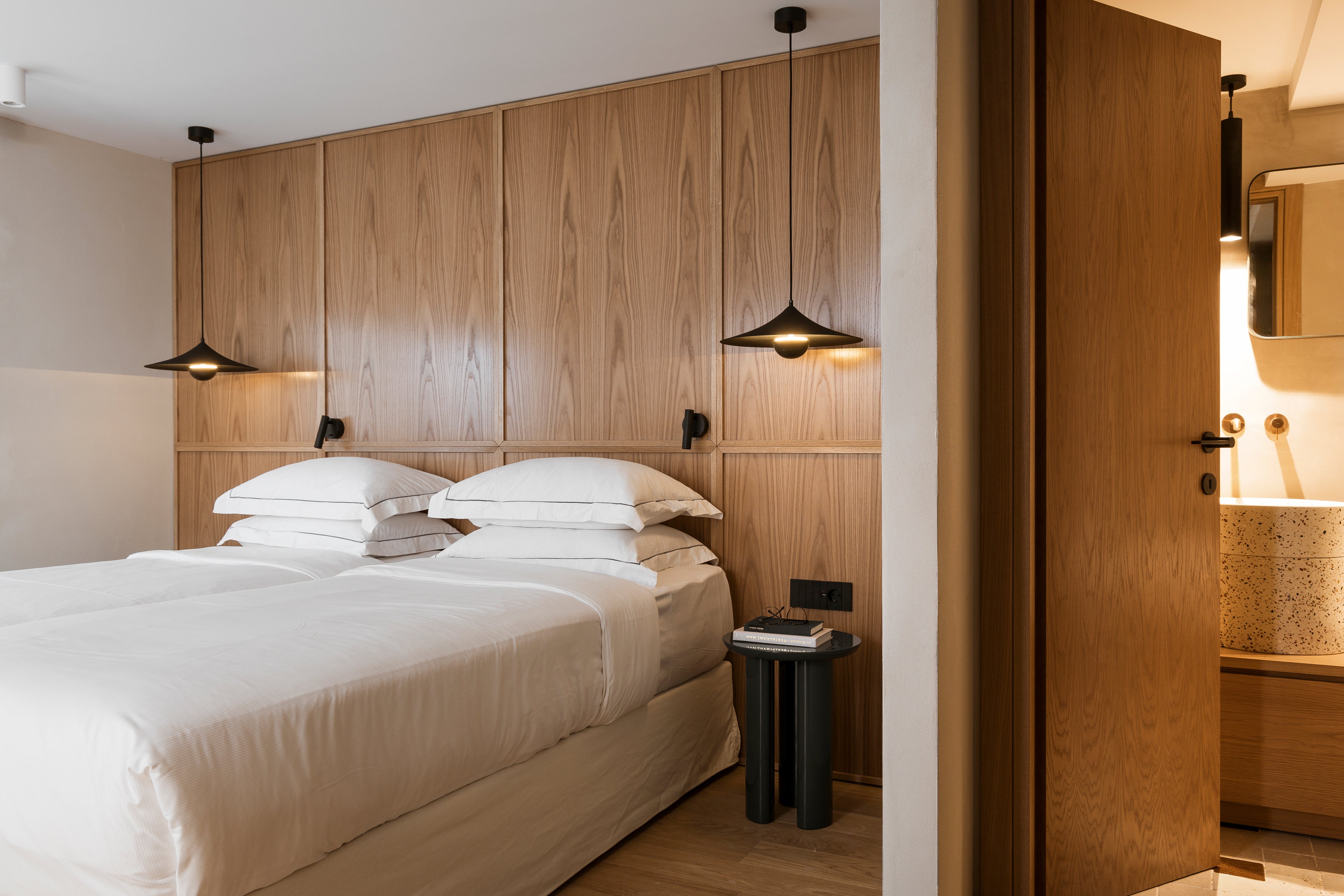 Modern bedroom with wooden headboard and white bedding