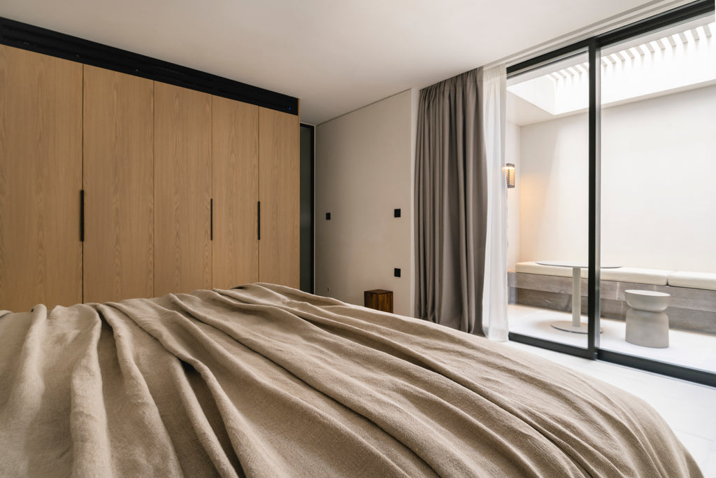 Modern bedroom with wooden wardrobe and large window