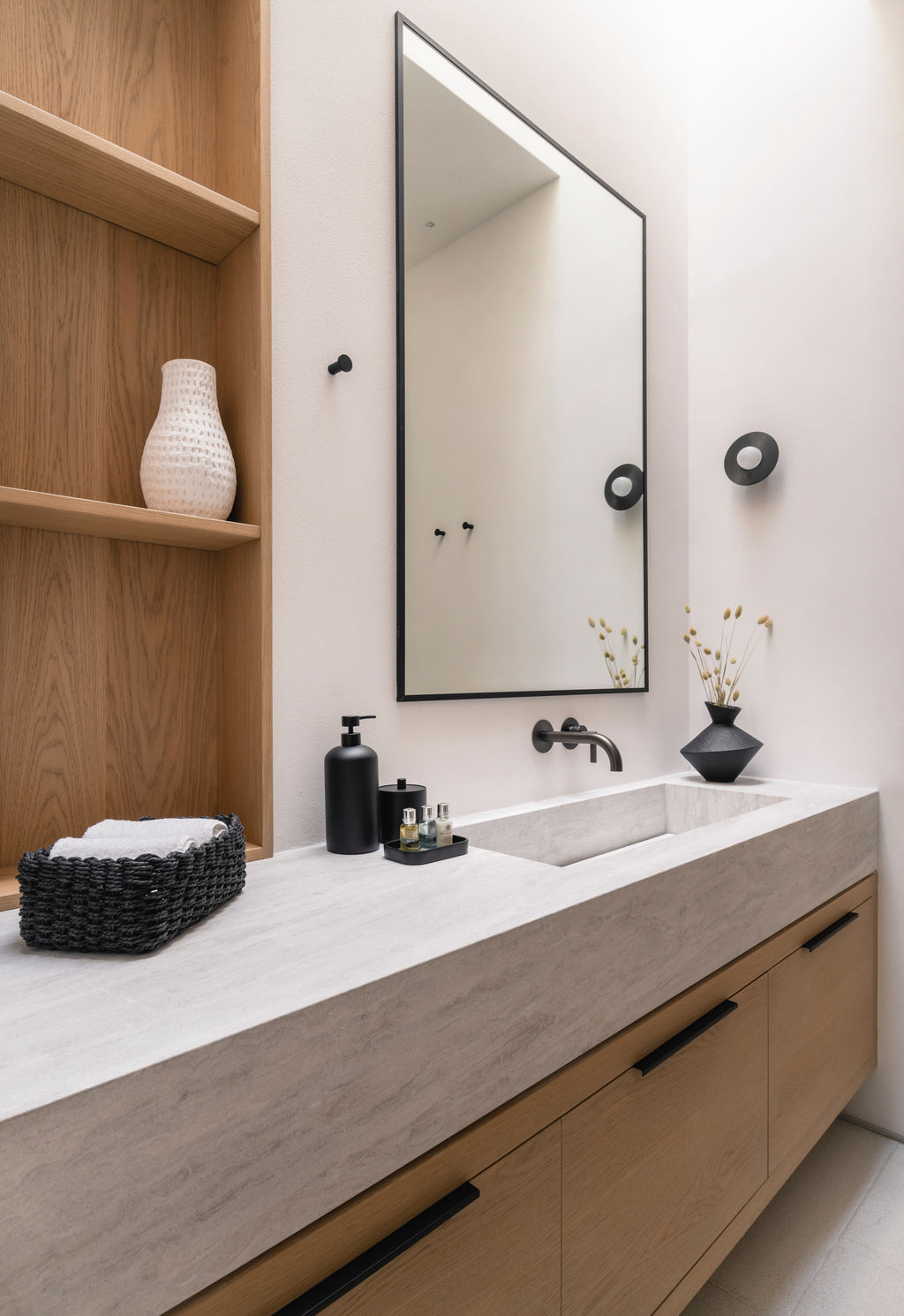 Bathroom vanity with mirror, sink, and decorative items.