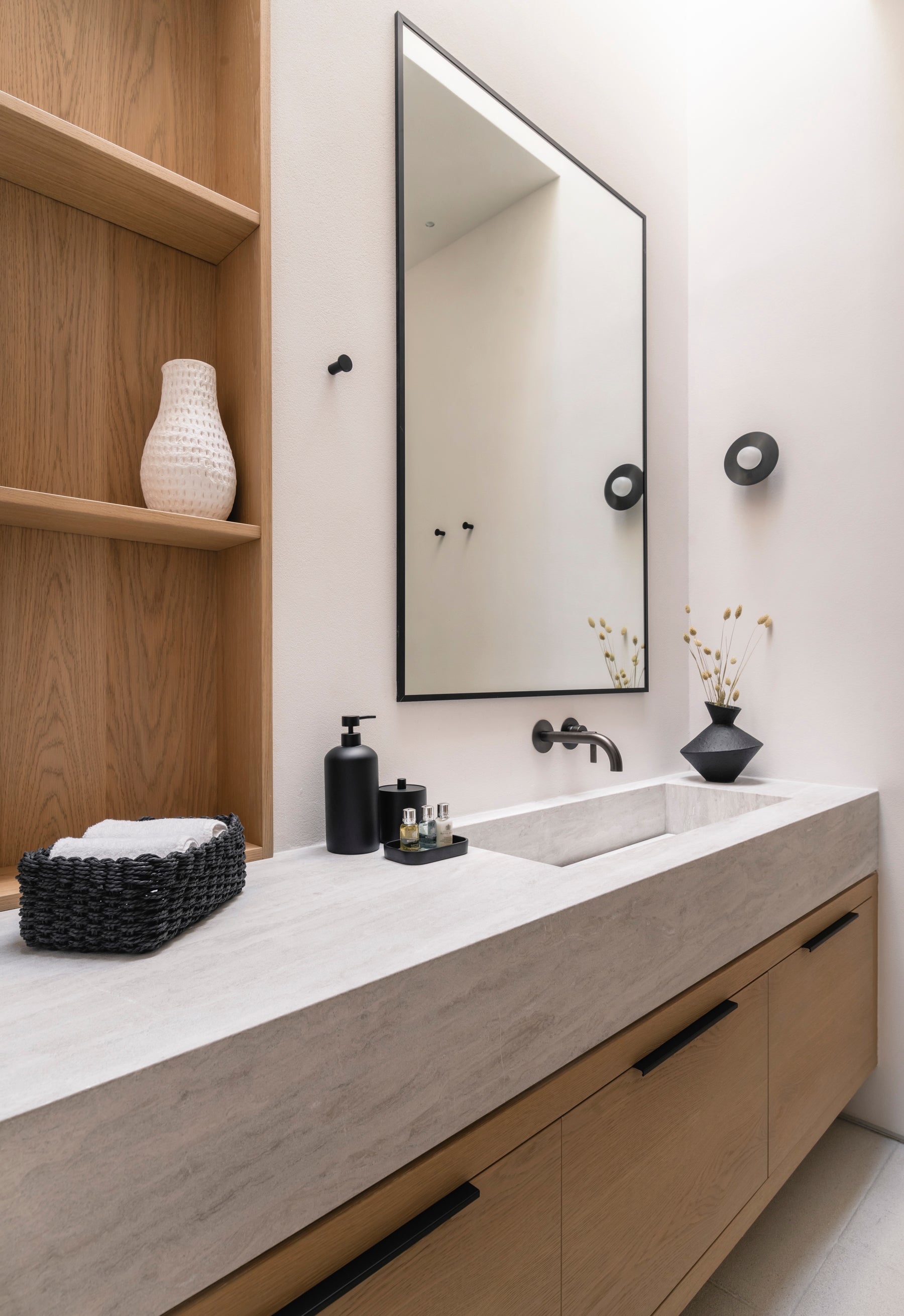 Bathroom vanity with mirror, sink, and decorative items.