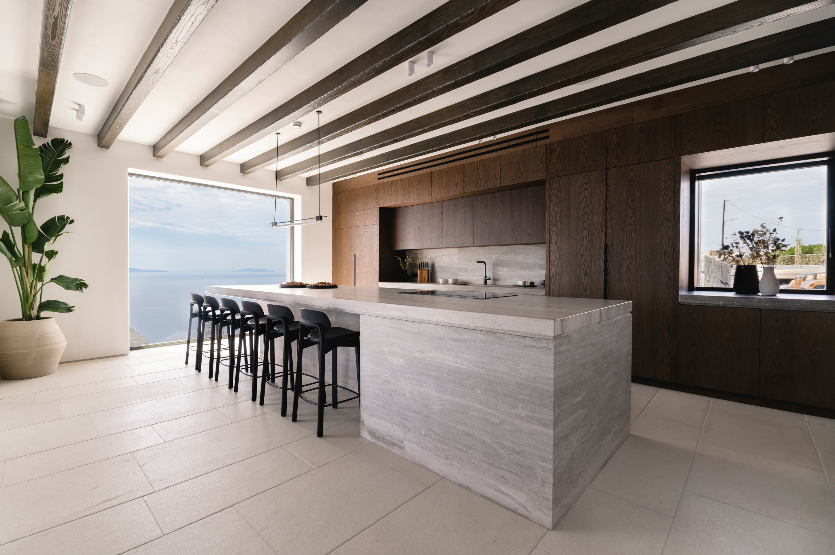 Modern kitchen with wooden beams and a large window view