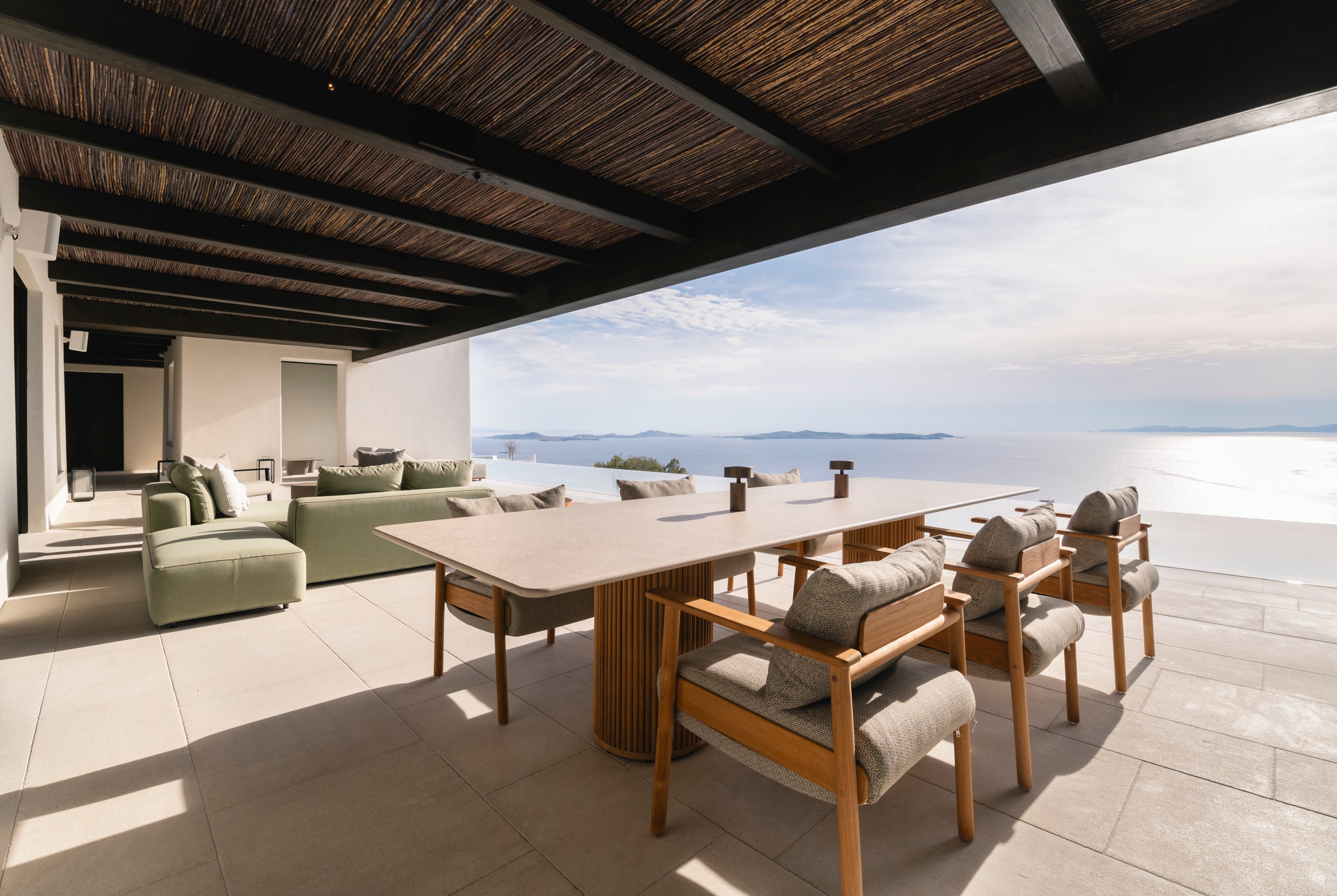 Outdoor patio with dining table and chairs overlooking a scenic view
