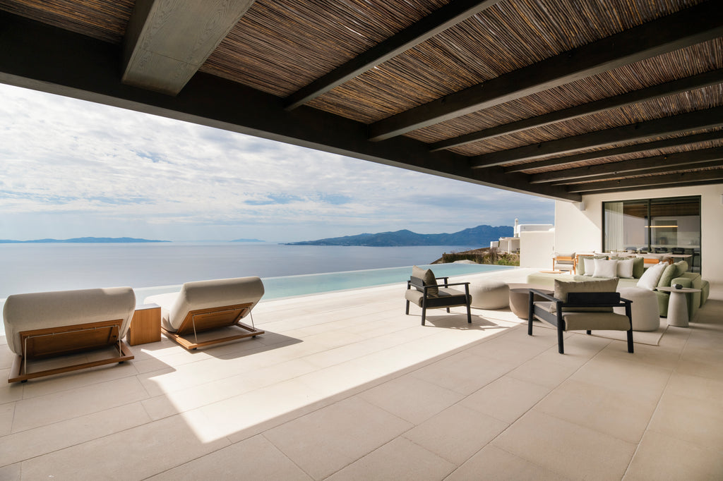 Modern outdoor patio with ocean view and stylish furniture