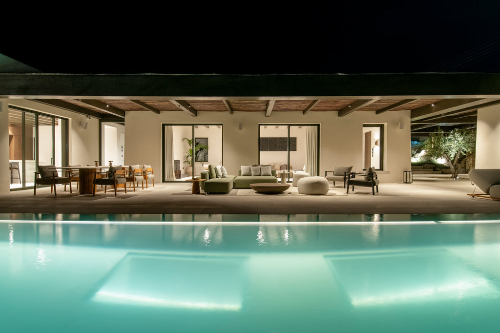 Modern outdoor patio area with pool at night