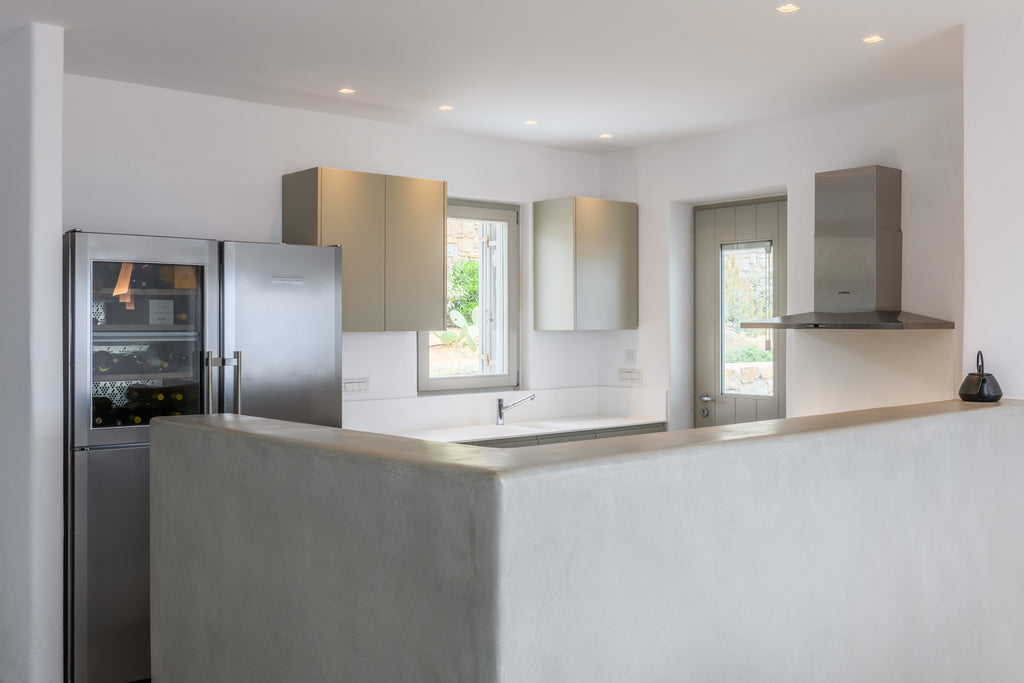 Modern kitchen with stainless steel appliances and white walls