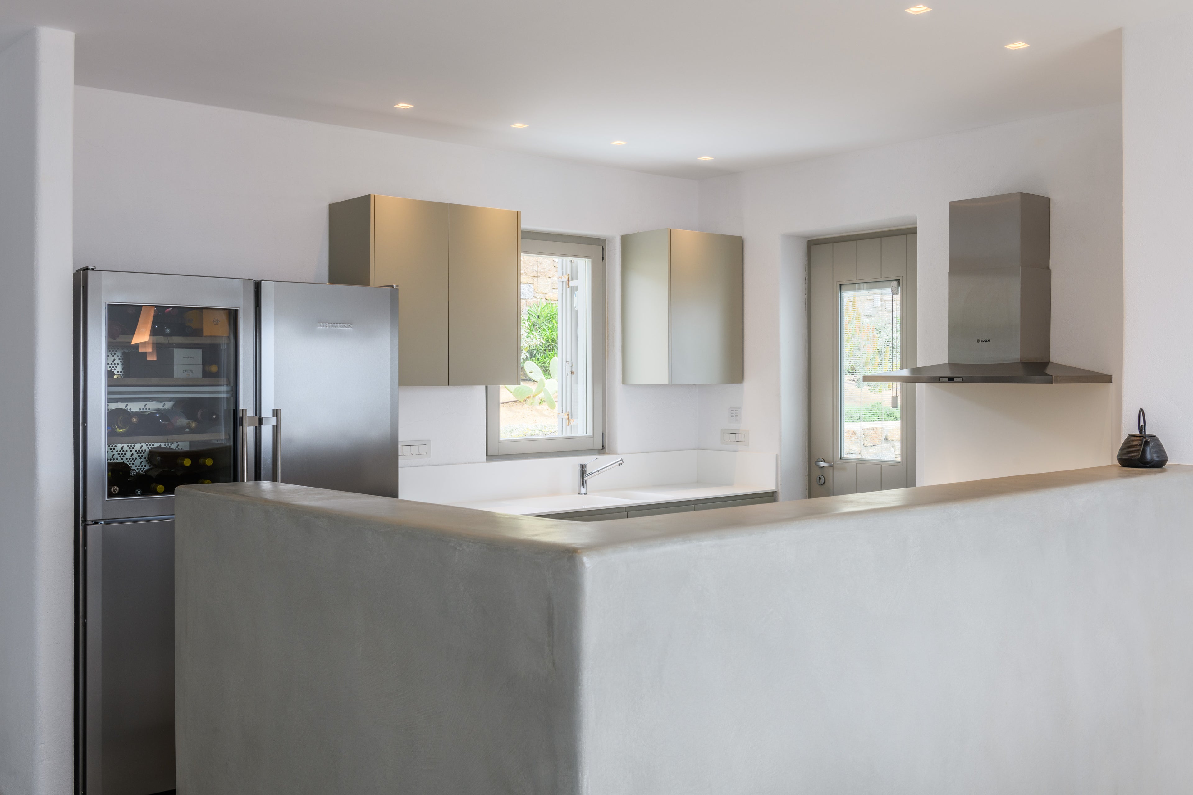 Modern kitchen with stainless steel appliances and white walls