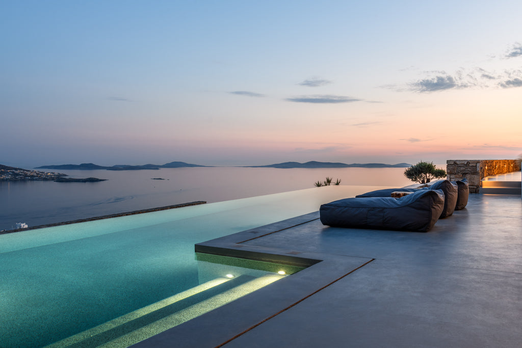Infinity pool with ocean view at sunset